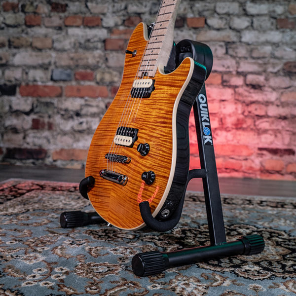 guitar stand shown with electric guitar